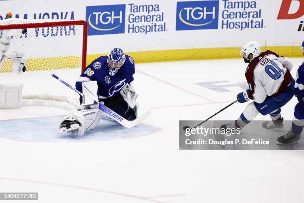 Nazem Kadri of the Colorado Avalanche scores a goal against Andrei Vasilevskiy of the Tampa Bay Lightning to win 3-2 in overtime in Game Four of the...