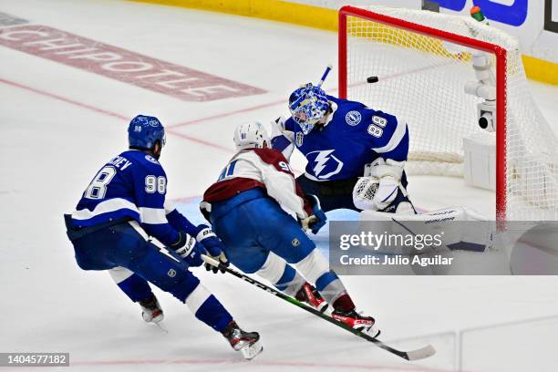 Nazem Kadri of the Colorado Avalanche scores a goal against Andrei Vasilevskiy of the Tampa Bay Lightning to win 3-2 in overtime in Game Four of the...
