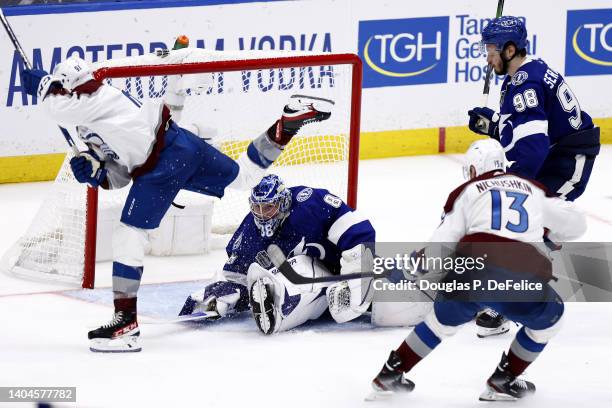 Nazem Kadri of the Colorado Avalanche scores a goal against Andrei Vasilevskiy of the Tampa Bay Lightning to win 3-2 in overtime in Game Four of the...