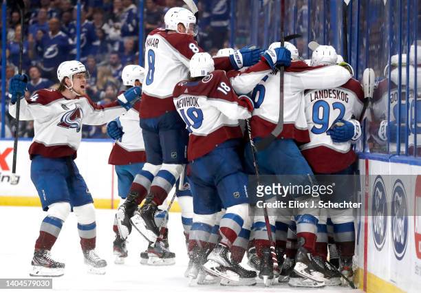 Cale Makar and the Colorado Avalanche celebrate the game winning goal by Nazem Kadri who scored in overtime to defeat the Tampa Bay Lightning 3-2 in...