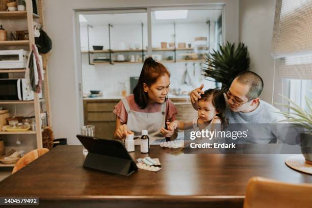 asian toddler girl get sick, illness, fever. - medicine cabinet stock pictures, royalty-free photos & images