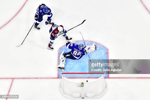 Nazem Kadri of the Colorado Avalanche scores a goal against Andrei Vasilevskiy of the Tampa Bay Lightning to win 3-2 in overtime in Game Four of the...