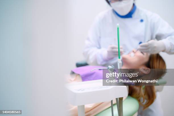 senior female dentist checking patient's teeth in office - narkosemittel stock-fotos und bilder