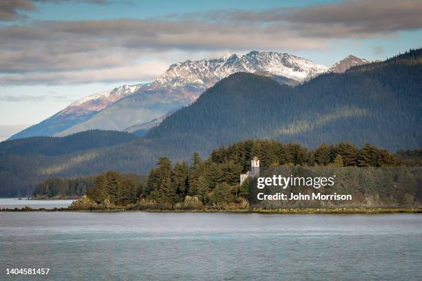 sentinel island lighthouse in the alaska inside passage near juneau, alaska usa - alaska coastline stock pictures, royalty-free photos & images