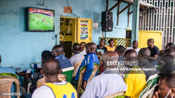 Nigerian fans watch a match in a makeshift restaurant run by a Nigerian man in a working class area of Libreville during the Nigeria-Tunisia match on...