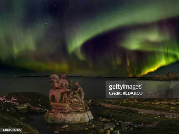 Northern lights over the Mother of the sea, Sassuma Arnaa - a legendary figure in Inuit culture. Sculpure by Christian Rosing in the colonial harbour...