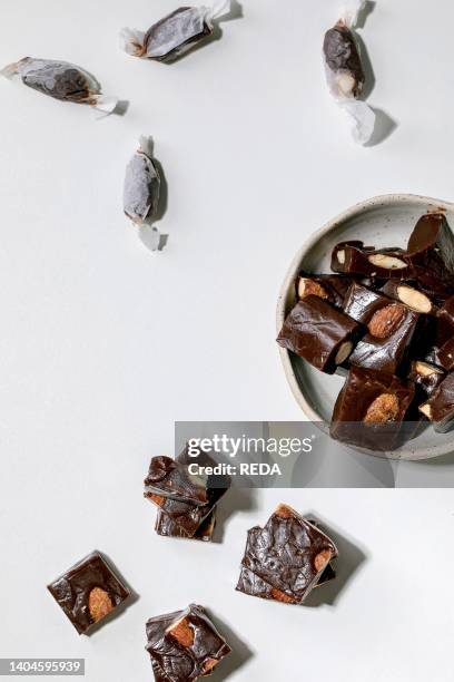 Homemade toffee salted caramel chocolate almond nuts candy on white table. Handmade food sweet gifts for any holidays. Flat lay.