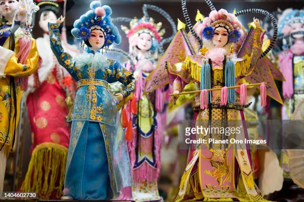 Peking Opera dolls in a Beijing shop window.