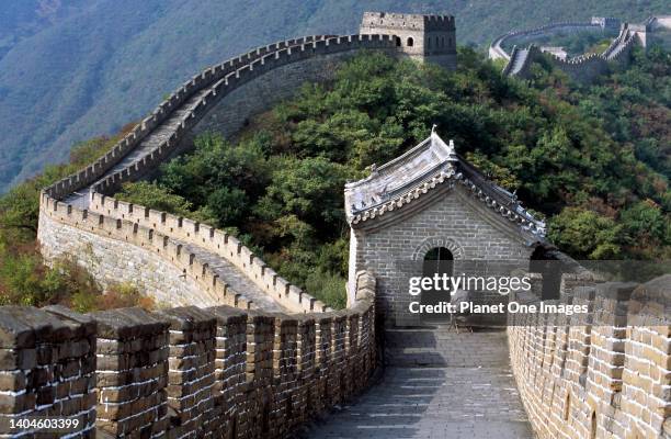 Seated man, the Great Wall at Badaling - a historic image.