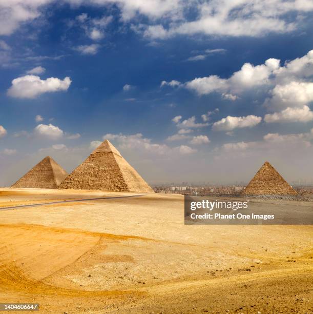 The pyramids at Giza, Egypt, Cairo in the background.
