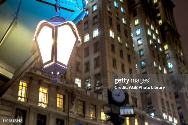 Sao Paulo, Brasil, . LAMPIaO. Vista noturna de um lustre em formato de lampiao na Praça Antônio Prado, com a fachada do Edifício Martinelli ao fundo,...