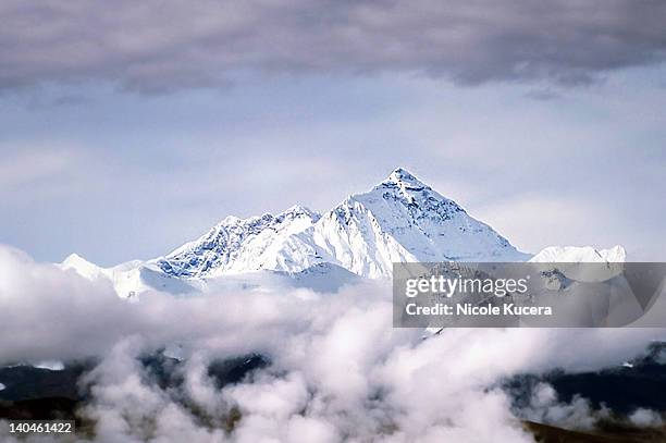 peak of mount everest above clouds in tibet - mount everest stockfoto's en -beelden