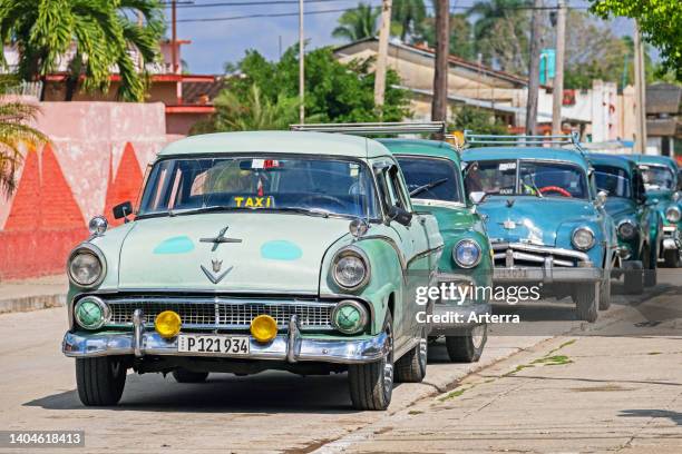 Parked American classic cars used as Cuban taxis in the town Jatibonico, Sancti Spíritus Province on the island Cuba, Caribbean.