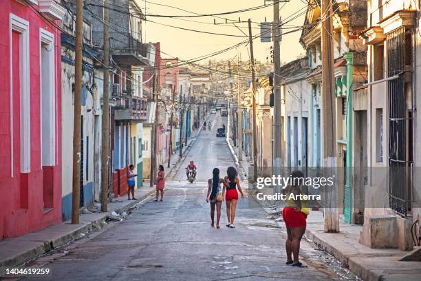 Afro-Cuban women walking street at sunset in the colonial city center of Matanzas on the island Cuba, Caribbean.