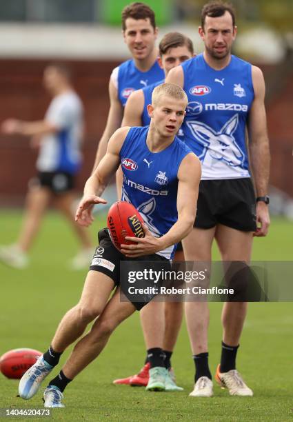 Jackson Archer of the Kangaroos controls the ball during a North Melbourne Kangaroos AFL training session at Arden Street Ground on June 23, 2022 in...