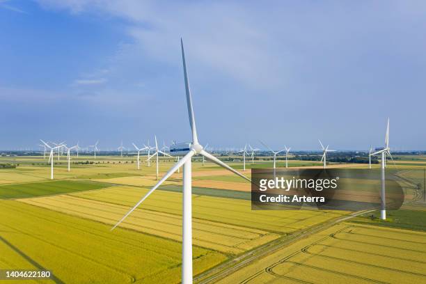 Aerial view over farmland with wind turbines at wind farm in North Frisia, Schleswig-Holstein, Germany.