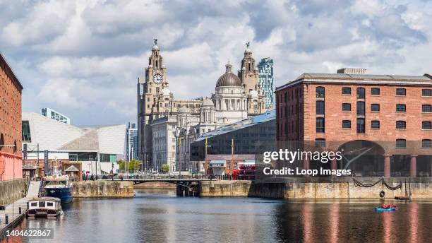 Canoes on the Royal Albert Dock in front of the Three Graces.