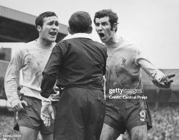 Chelsea Football Club captain Ron Harris and centre forward Peter Osgood protest to referee Kevin Howley after a penalty kick was ordered to be...