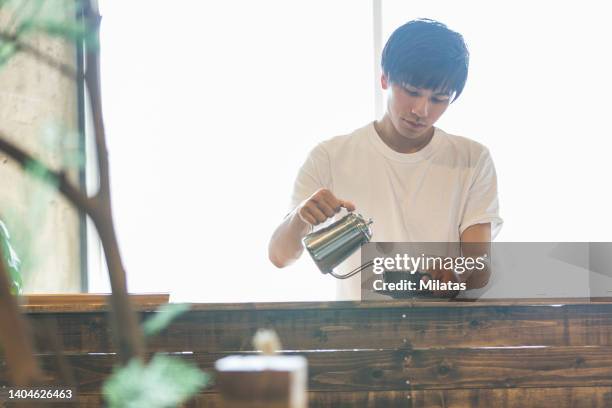 a cafe clerk brewing coffee - やかん　日本 ストックフォトと画像