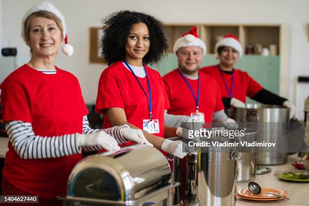 volunteers ready to serve in a soup kitchen - volunteer aged care stock pictures, royalty-free photos & images