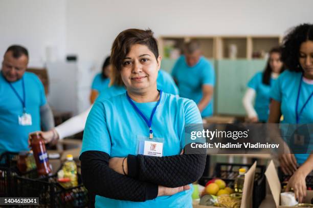 portrait of a public-spirited volunteer - food distribution stock pictures, royalty-free photos & images