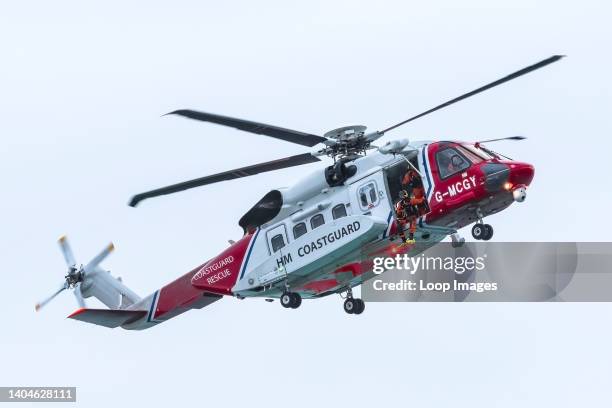 Sikorsky S-92A G-MCGY HM Coastguard Helicopter based at Cornwall Airport Newquay flying overhead on an emergency callout at Fistral in Newquay in...