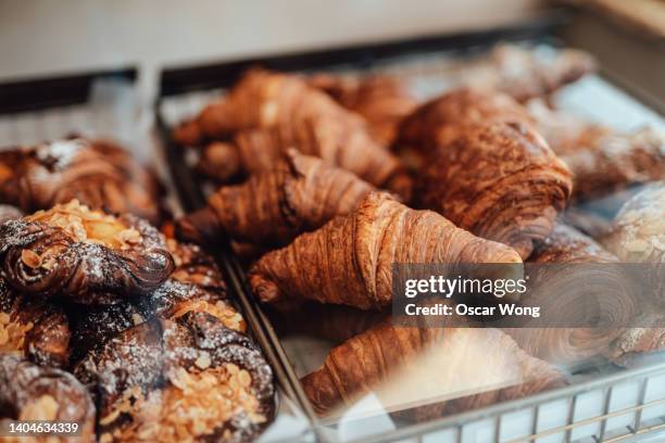 close-up of fresh french baked pastry in the display cabinet in a cafe. - englische tea time stock-fotos und bilder