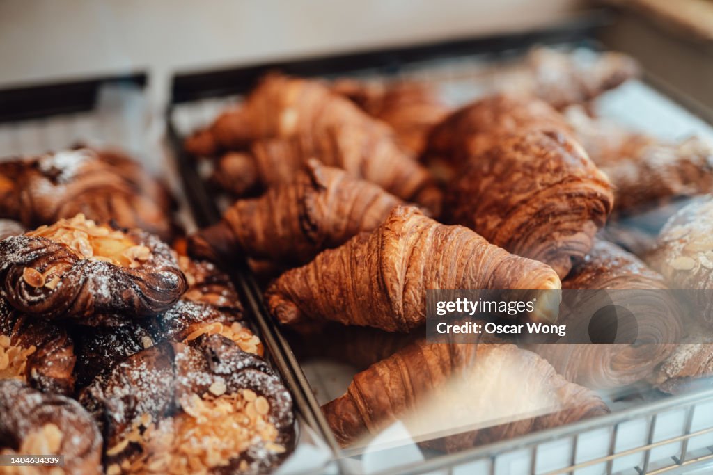 Close-up of fresh French baked pastry in the display cabinet in a cafe.