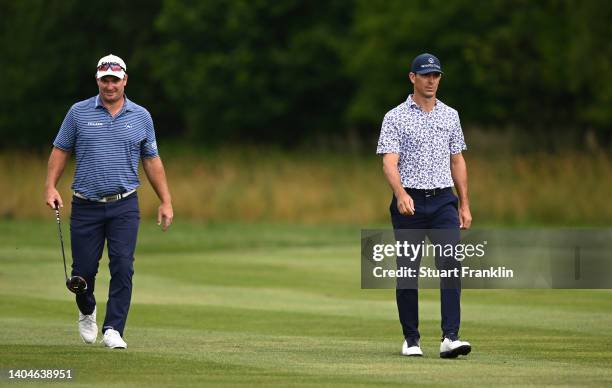 Ryan Fox of New Zealand and Billy Horschel of the USA walks down the 15th hole during the first round of the BMW International Open at Golfclub...