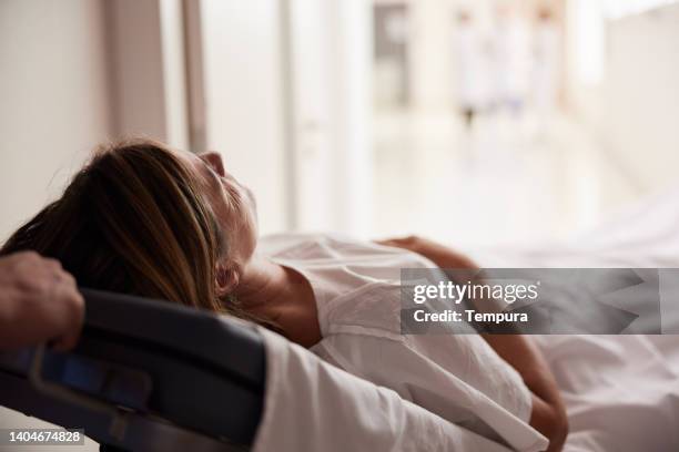 a patient in a stretcher in a hospital. - hospital gurney stock pictures, royalty-free photos & images