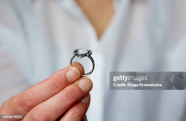 holding a ring - man holding engagement ring stock pictures, royalty-free photos & images