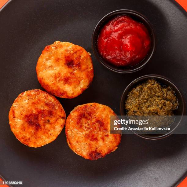 cutlets and sauces in a black plate. meatballs - cutlet bildbanksfoton och bilder