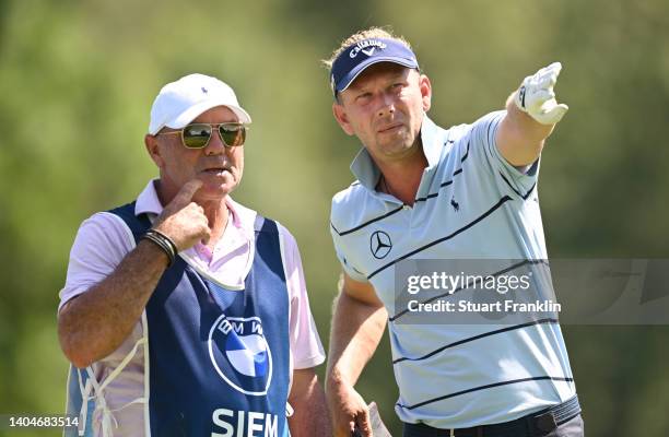 Marcel Siem of Germany consults his caddie, Kyle Roadley before teeing off on the 11th hole during the first round of the BMW International Open at...