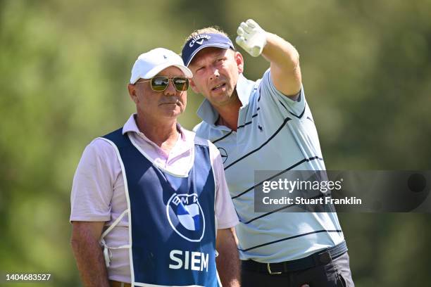 Marcel Siem of Germany consults his caddie, Kyle Roadley before teeing off on the 11th hole during the first round of the BMW International Open at...