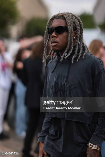 Destroy Lonely seen wearing a black Givenchy sunglasses and a washed black hoodie from Givenchy, outside the Givenchy show, during Paris Fashion Week...
