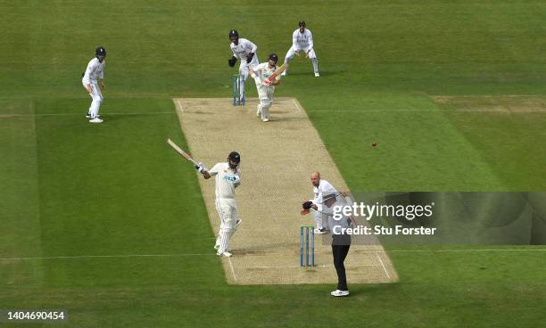 New Zealand batsman Henry Nicholls drives watched by Ben Foakes only to caught by Alex Lees via the bat of Daryl Mitchell at the non strikers end...