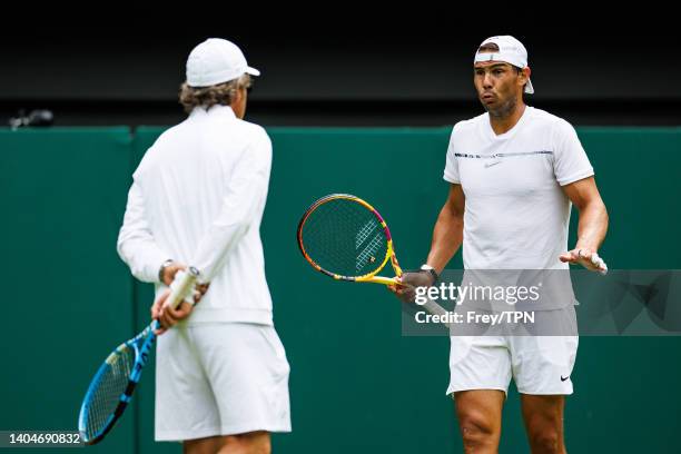 Rafael Nadal of Spain practices on centre court at the AELTC with coaches Francisco Roig and Marc Lopez in a historic first time ever use of centre...