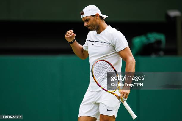 Rafael Nadal of Spain practices on centre court at the AELTC with coaches Francisco Roig and Marc Lopez in a historic first time ever use of centre...