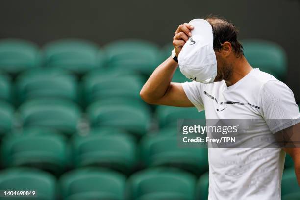 Rafael Nadal of Spain practices on centre court at the AELTC with coaches Francisco Roig and Marc Lopez in a historic first time ever use of centre...