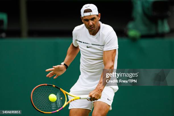 Rafael Nadal of Spain practices on centre court at the AELTC with coaches Francisco Roig and Marc Lopez in a historic first time ever use of centre...