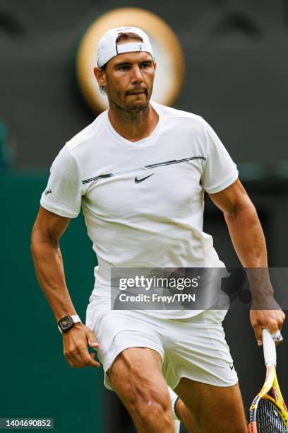 Rafael Nadal of Spain practices on centre court at the AELTC with coaches Francisco Roig and Marc Lopez in a historic first time ever use of centre...