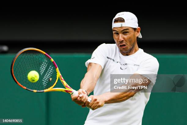 Rafael Nadal of Spain practices on centre court at the AELTC with coaches Francisco Roig and Marc Lopez in a historic first time ever use of centre...