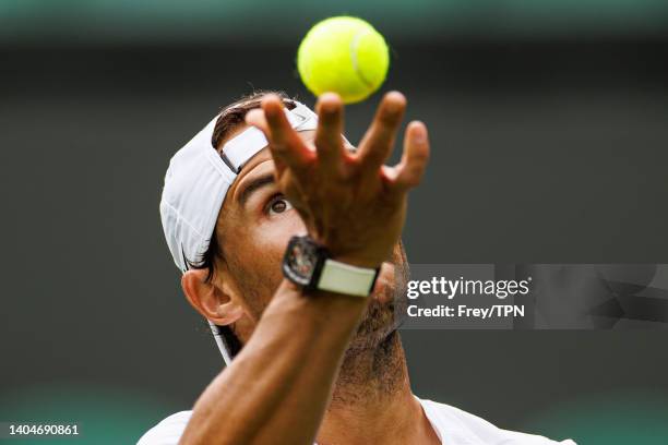 Rafael Nadal of Spain practices on centre court at the AELTC with coaches Francisco Roig and Marc Lopez in a historic first time ever use of centre...