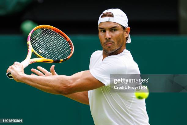 Rafael Nadal of Spain practices on centre court at the AELTC with coaches Francisco Roig and Marc Lopez in a historic first time ever use of centre...