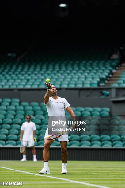 Rafael Nadal of Spain practices on centre court at the AELTC with coaches Francisco Roig and Marc Lopez in a historic first time ever use of centre...