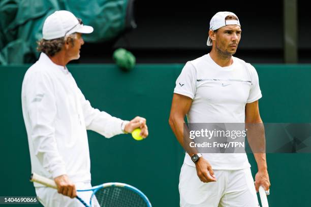 Rafael Nadal of Spain practices on centre court at the AELTC with coaches Francisco Roig and Marc Lopez in a historic first time ever use of centre...