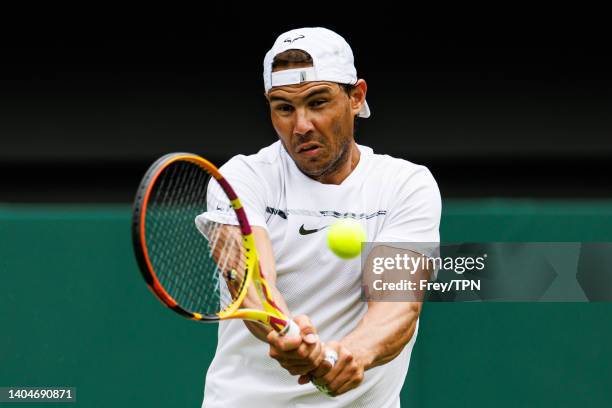 Rafael Nadal of Spain practices on centre court at the AELTC with coaches Francisco Roig and Marc Lopez in a historic first time ever use of centre...