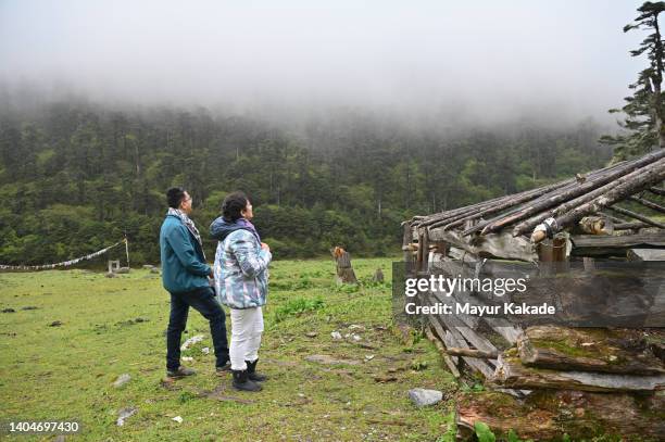 couple looking at a wooden structure while exploring nature - northeast india stock pictures, royalty-free photos & images