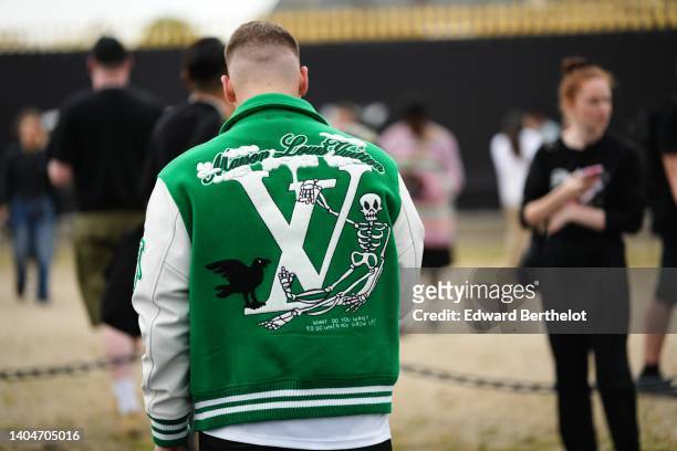 Guest wears a green felt and white leather sleeves with embroidered LV logo pattern teddy coat from Louis Vuitton, a white t-shirt, outside the...