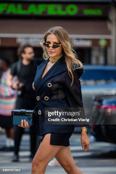 Ginta Kubiliute is seen wearing Nicolas Besson head to toe, navy striped strong shoulder blazer, skirt, heels, bag Louis Vuitton outside Rhude on...